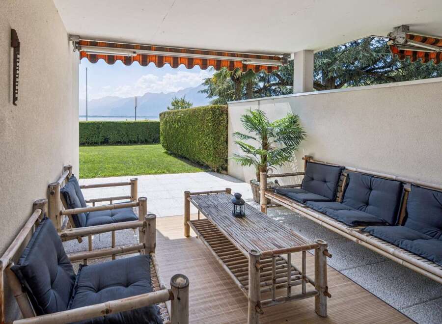 Enjoy outdoor living on this charming patio, complete with a bamboo sofa and chairs perfect for relaxing.