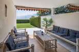 Enjoy outdoor living on this charming patio, complete with a bamboo sofa and chairs perfect for relaxing.