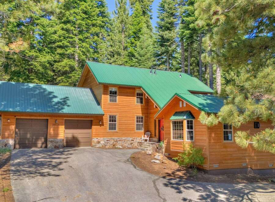 Nestled amidst towering pine trees, this charming wooden home offers a serene mountain retreat.