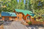 Nestled amidst towering pine trees, this charming wooden home offers a serene mountain retreat.