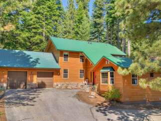 Nestled amidst towering pine trees, this charming wooden home offers a serene mountain retreat.