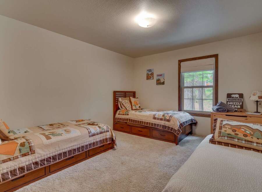 This charming bedroom features three twin beds, perfect for accommodating family or guests.