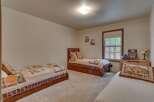 This charming bedroom features three twin beds, perfect for accommodating family or guests.