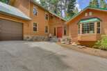 Nestled amidst tall pines, this charming wooden home offers a serene retreat.