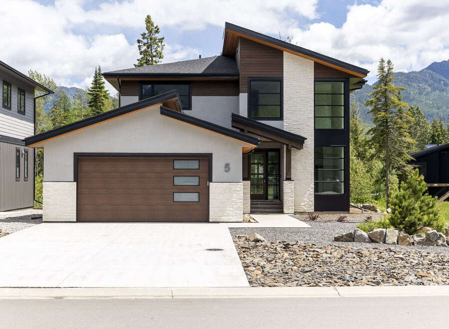Experience modern mountain living in this stunning architectural home, featuring a striking combination of stone, wood, and stucco finishes.