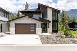 Experience modern mountain living in this stunning architectural home, featuring a striking combination of stone, wood, and stucco finishes.