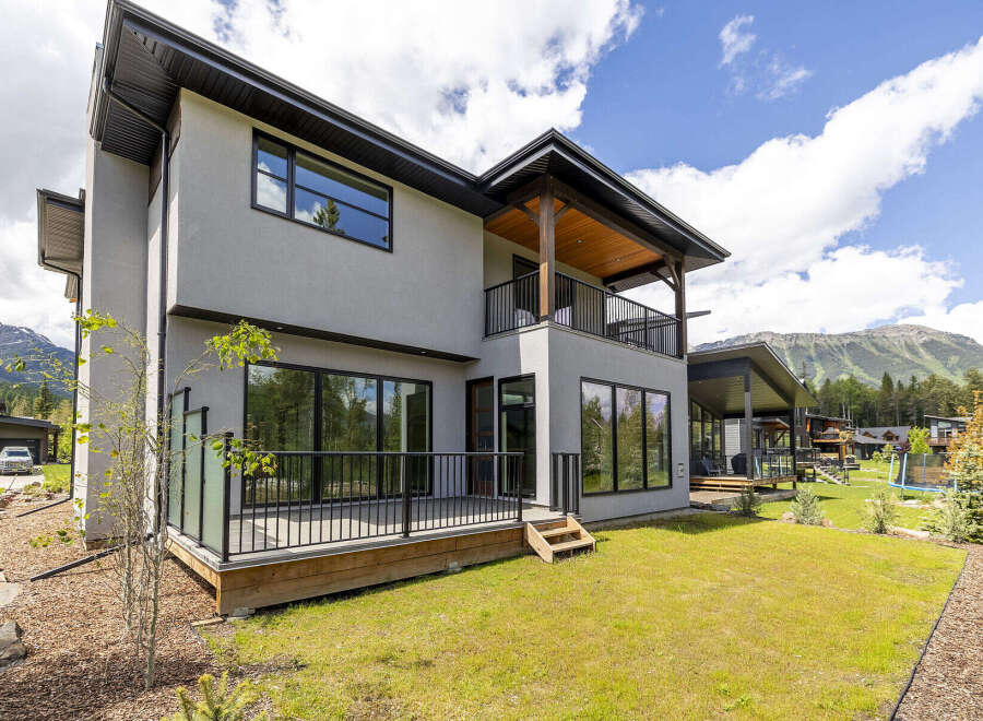 Experience modern luxury living in this stunning home, featuring expansive windows that flood the interior with natural light and offer breathtaking mountain views.