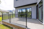Experience modern living with this stunning property featuring a spacious deck and large windows that offer breathtaking mountain views.
