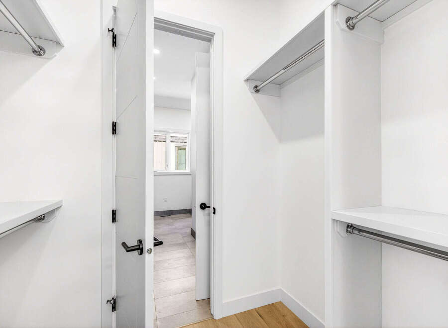 Step into this spacious walk-in closet, featuring ample shelving and hanging space to organize your wardrobe.