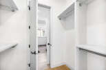 Step into this spacious walk-in closet, featuring ample shelving and hanging space to organize your wardrobe.
