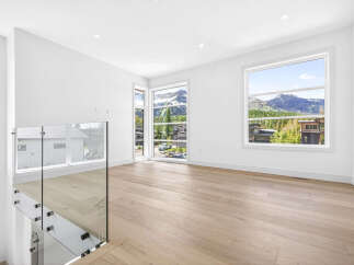 Experience breathtaking mountain views from this modern interior space, featuring expansive windows that flood the room with natural light.