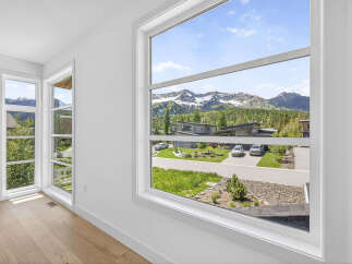 Experience breathtaking mountain views from this stunning property, framed by expansive windows that bring the outdoors in.