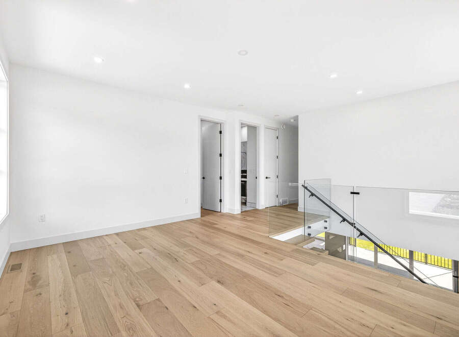 Experience modern living in this spacious, open-concept home featuring gleaming hardwood floors throughout.