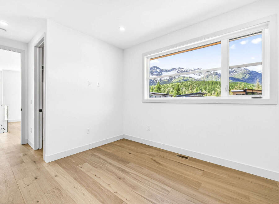 Experience breathtaking mountain views from this stunning room, featuring a large window that floods the space with natural light.