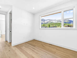 Experience breathtaking mountain views from this stunning room, featuring a large window that floods the space with natural light.