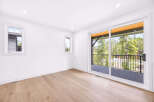 Step into this bright and airy bedroom, featuring a large sliding glass door that opens to a scenic balcony with stunning mountain and forest views.