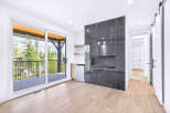 Experience modern living with this stunning room featuring a sleek, dark-tiled fireplace as the centerpiece.
