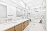 Experience modern luxury in this stunning bathroom, featuring a sleek double vanity with contemporary faucets and ample storage.