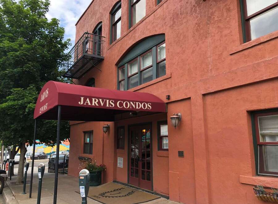 Discover comfortable living at Jarvis Condos, featuring a welcoming entrance with a prominent awning and double doors.