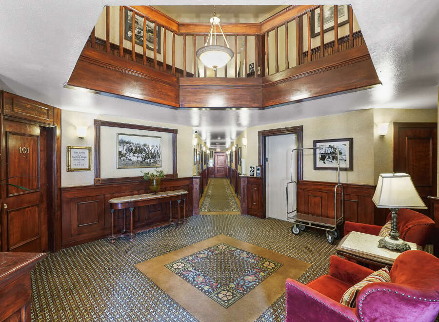 Step into a timeless ambiance with this charming hotel lobby, featuring rich wood paneling and elegant vintage decor.