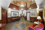 Step into a timeless ambiance with this charming hotel lobby, featuring rich wood paneling and elegant vintage decor.