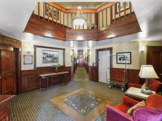 Step into a timeless ambiance with this charming hotel lobby, featuring rich wood paneling and elegant vintage decor.