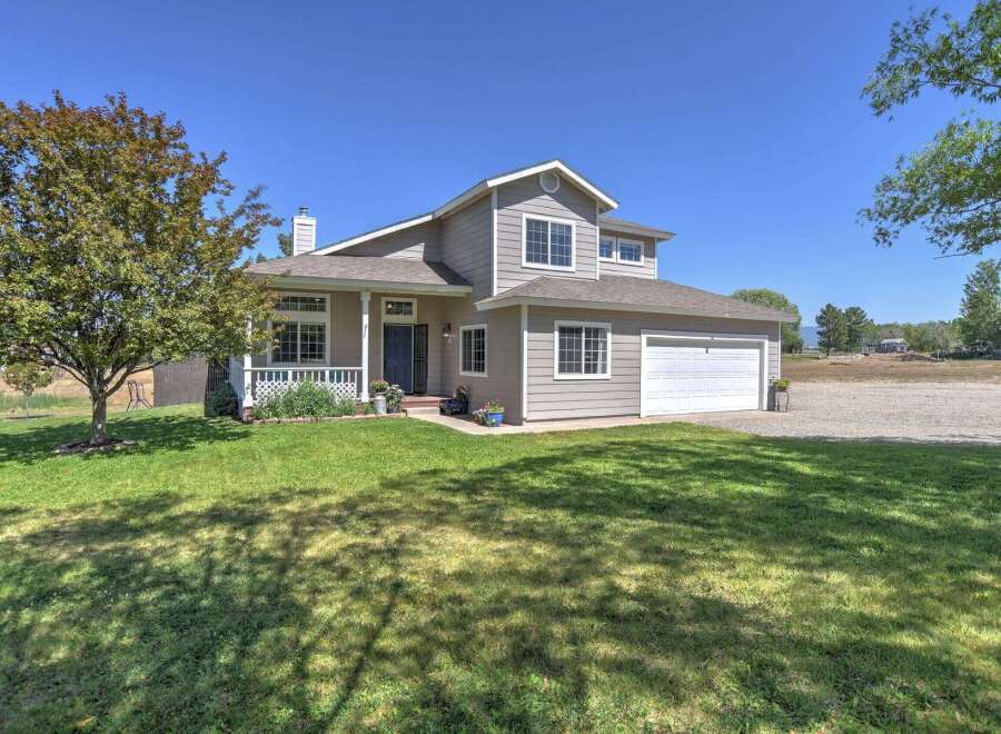 Discover this charming two-story home featuring a welcoming front porch and a spacious two-car garage.