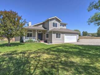 Discover this charming two-story home featuring a welcoming front porch and a spacious two-car garage.