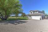 Discover this charming two-story home featuring a spacious gravel driveway leading to an attached two-car garage.