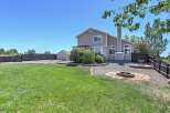 Enjoy outdoor living in this spacious backyard featuring a fire pit area perfect for gatherings and a convenient shed for storage.