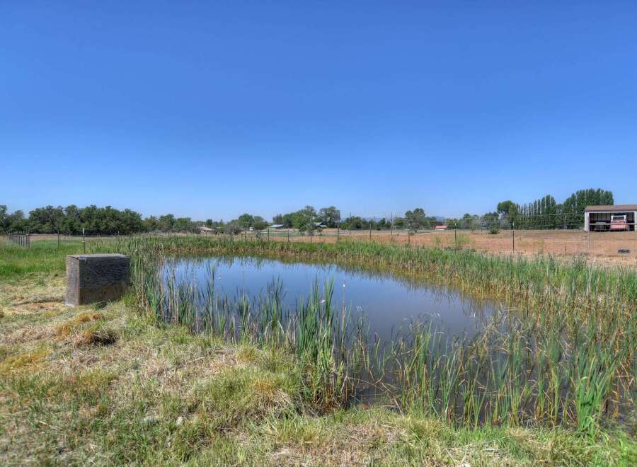 Discover a tranquil oasis with this charming property featuring a serene pond, perfect for relaxation and enjoying nature's beauty.