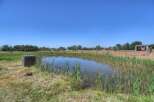 Discover a tranquil oasis with this charming property featuring a serene pond, perfect for relaxation and enjoying nature's beauty.