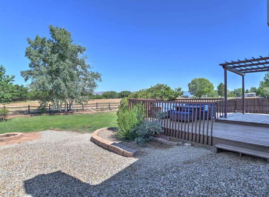 Enjoy outdoor living with this spacious deck and pergola, perfect for entertaining or relaxing.