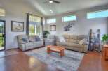 Step into this inviting living room featuring comfortable reclining sofas and a unique wooden coffee table, perfect for gatherings.