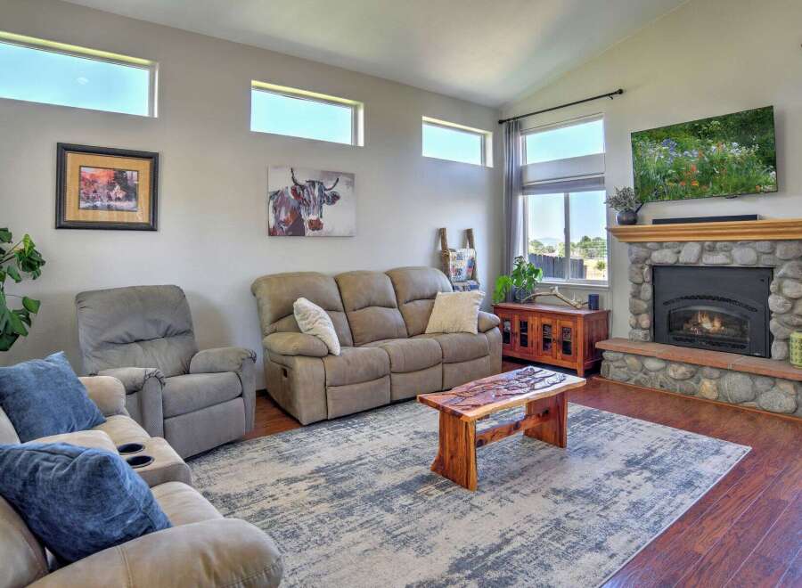 Experience comfort and style in this inviting living room, featuring a plush sofa and recliner perfect for relaxation.