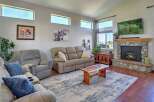 Experience comfort and style in this inviting living room, featuring a plush sofa and recliner perfect for relaxation.