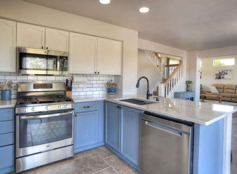 Experience the heart of this home with a beautifully updated kitchen featuring crisp white subway tile backsplash and two-toned cabinetry.