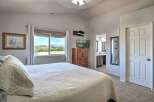 Experience comfort and convenience in this inviting bedroom, featuring a large window with stunning mountain views.