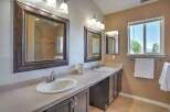 This spacious bathroom features a double vanity with two sinks and ample counter space, perfect for busy mornings.
