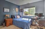 This charming bedroom features a comfortable blue comforter on the bed, perfect for a restful night's sleep.