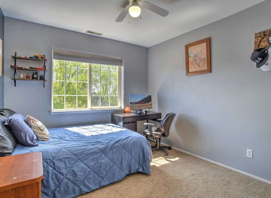 This bedroom features a comfortable blue comforter on the bed, perfect for a restful night's sleep.