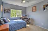This bedroom features a comfortable blue comforter on the bed, perfect for a restful night's sleep.