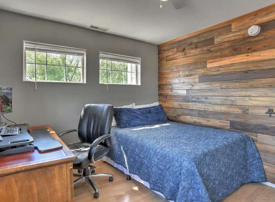 This bedroom features a rustic accent wall with horizontal wood planks, creating a warm and inviting atmosphere.