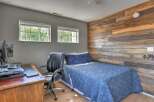 This bedroom features a rustic accent wall with horizontal wood planks, creating a warm and inviting atmosphere.