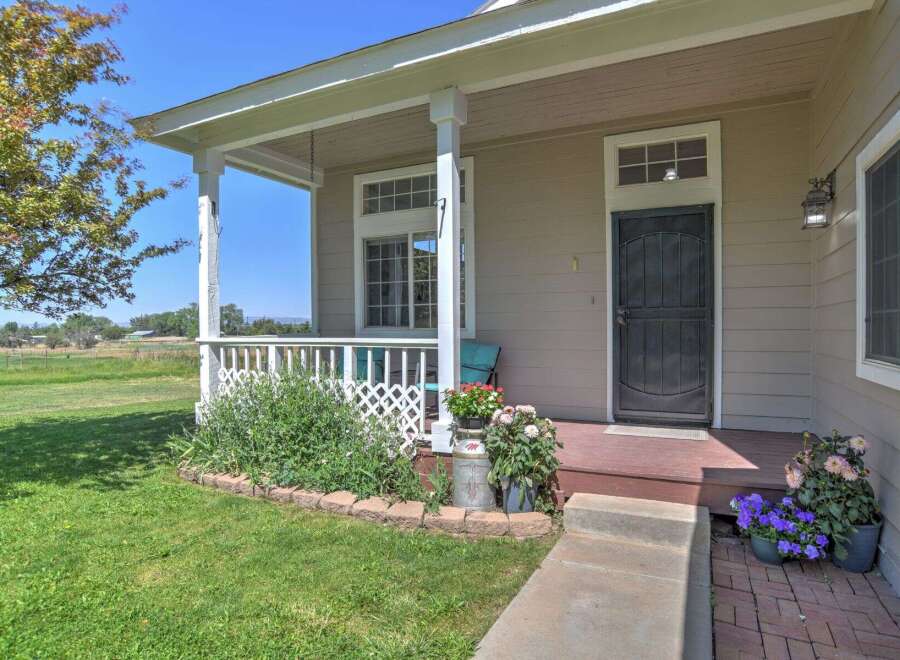 Charming home with a welcoming front porch, perfect for enjoying the serene rural surroundings.