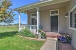 Charming home with a welcoming front porch, perfect for enjoying the serene rural surroundings.