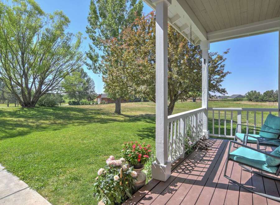 Enjoy the serene country lifestyle from this charming porch, perfect for morning coffee or evening relaxation.