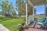 Enjoy the serene country lifestyle from this charming porch, perfect for morning coffee or evening relaxation.