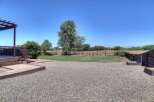 Enjoy outdoor living with this spacious backyard featuring a large wooden deck and pergola, perfect for entertaining.
