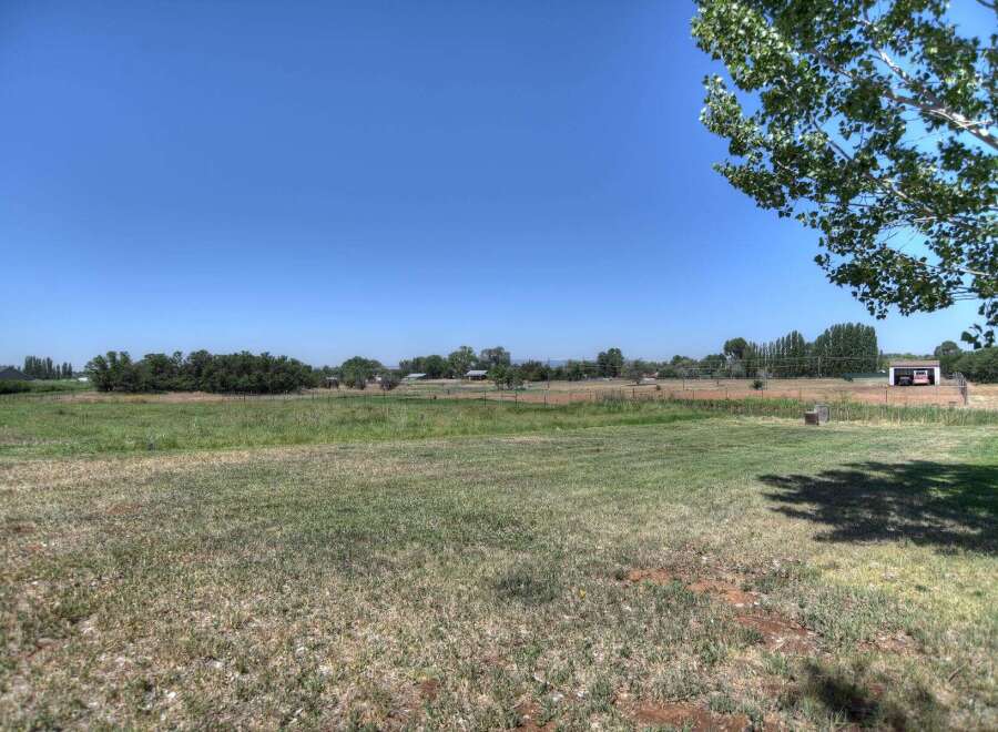 Discover this expansive property featuring a large, open grassy field perfect for outdoor activities or future development.